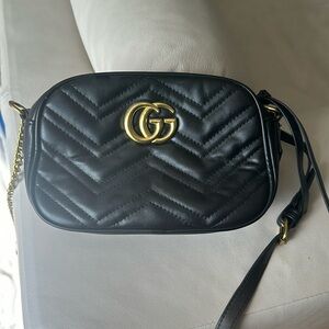 Black and gold oval bag